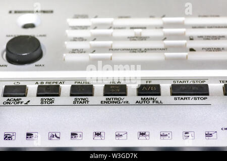Old music keyboard synthesizer control panel with knobs and volume control in selective focus Stock Photo