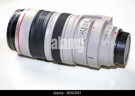 Canon telephoto zoom lens of 100-400 millimeter with control switches in close up view isolated on white background Stock Photo