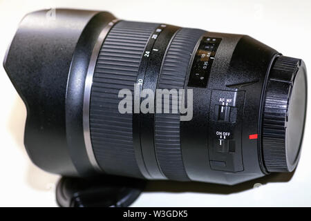 Ultra wide angle Tamron photography lens 15-30mm with lens cap on white background Stock Photo