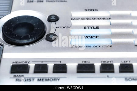 Old music keyboard synthesizer control panel with knobs and volume control in selective focus Stock Photo