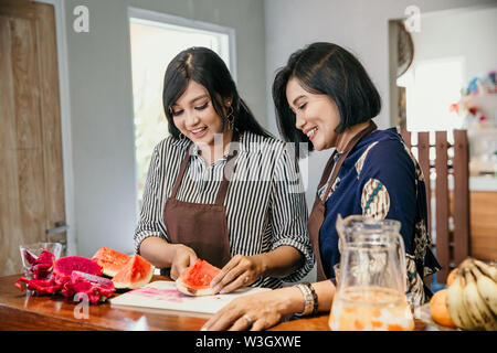 Portrait of two woman make a dish from slice a dragon fruit Stock Photo