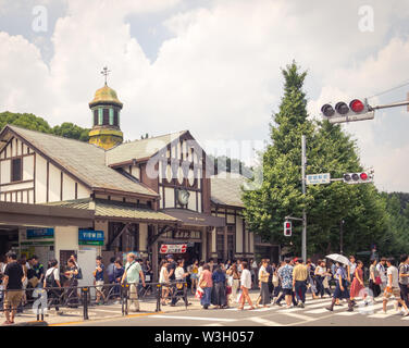 People and crowds outside of the busy Harajuku Station building, a train station in Harajuku, Tokyo, Japan. Stock Photo