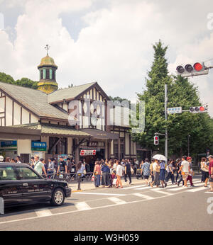 People and crowds outside of the busy Harajuku Station building, a train station in Harajuku, Tokyo, Japan. Stock Photo