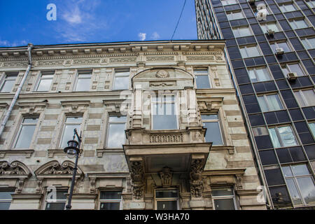 Bay window on a house that was built in the nineteenth century. Art Nouveau style. Adjacent to the office building. Site about architecture, history. Stock Photo