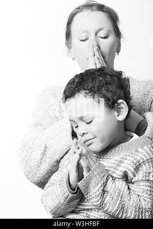 Mother with child praying together stock image and stock photo Stock Photo