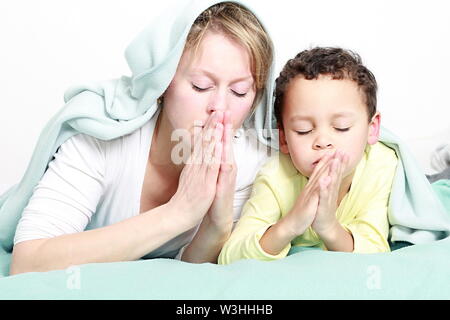 Mother with child praying together stock image and stock photo Stock Photo