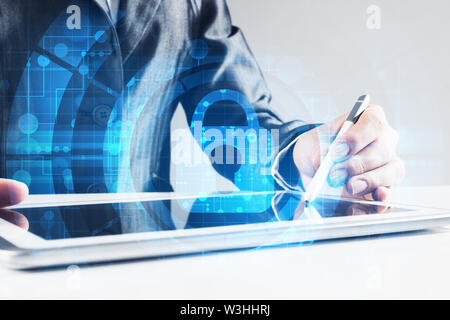 Close up of female hands using tablet and lock icon on screen Stock Photo