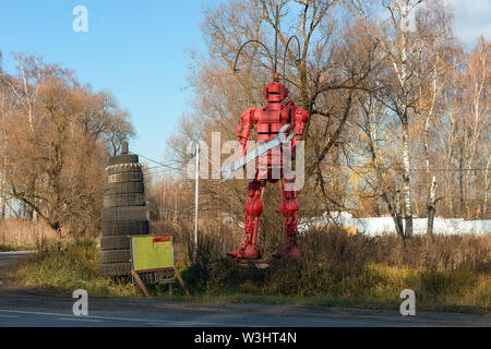 MOSCOW REGION, RUSSIA - NOVEMBER 3, 2018: Installation on the side of a road, a robot with a wrench invites you to call in the auto repair shop Stock Photo