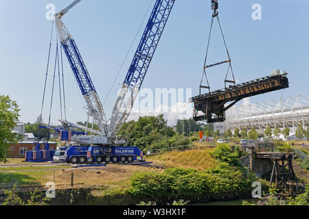 Pictured: A crane lifts the Bascule Bridge over river Tawe in the Morfa area of Swansea, south Wales. Sunday 14 July 2019 Re: A 110 year old bridge ha Stock Photo