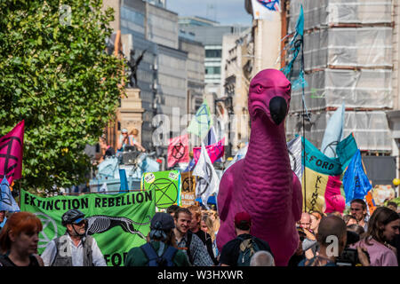 London, UK. 15th July 2019. The march to the camp near waterloo is led by the giant pink dodo - Extinction Rebellion block Fleet Street outside the Royal Courts of Justice as part of a new round of environmental protests, with their new blue boat the Polly Higgins - named after a woman who died of cancer on the April protest while promoting her idea for an Ecocide Law. Credit: Guy Bell/Alamy Live News Stock Photo