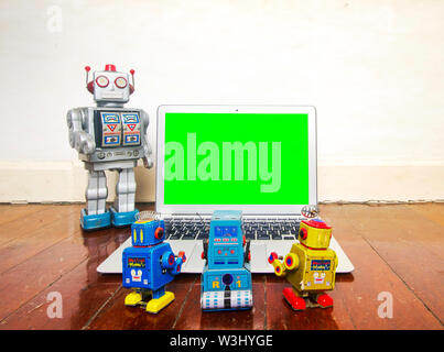 robot presentation  with laptop on a wooden floor Stock Photo