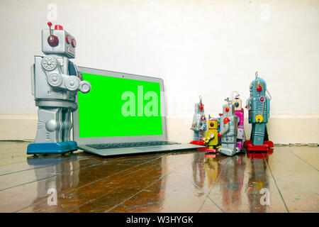 robot presentation  with laptop on a wooden floor Stock Photo