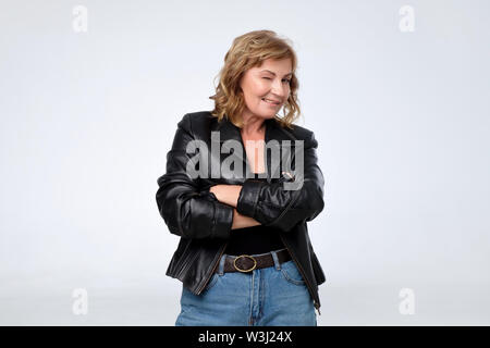 Mature pretty european woman in black leather jacket. Stock Photo