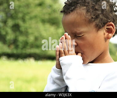 little boy praying to God and being religious stock image with hands held together praying in church on sunday stock photo Stock Photo