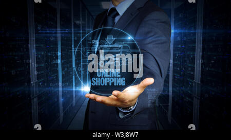 A businessman in a suit and the screen with cart hologram over hand. Man using and virtual display interface. Online shopping, internet business, netw Stock Photo