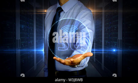Man with dynamic 5G symbol hologram on hand. Businessman and futuristic concept of mobile wireless network, communication technology, data transmition Stock Photo