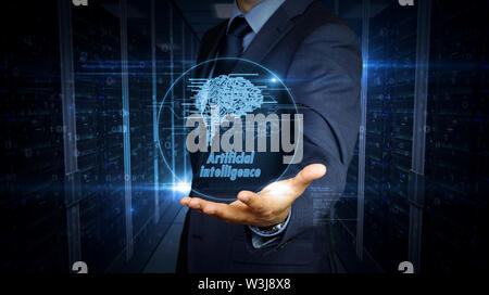 A businessman in a suit and the screen with cybernetic brain hologram. Man using hand on virtual display interface. Artificial intelligence, machine l Stock Photo