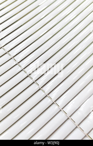 A venetian blind in white tone. There is landscape in the background Stock Photo