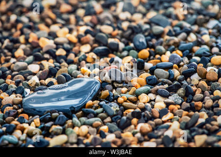 Abstract background with decorative floor pattern of sea gravel stones, Gravel texture with selective focus. Stock Photo