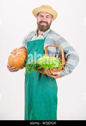 Bringing vegetables. man chef with rich autumn crop. bearded mature farmer. organic and natural food. happy halloween. harvest festival. seasonal vitamin food. Useful fruit and vegetable. Stock Photo