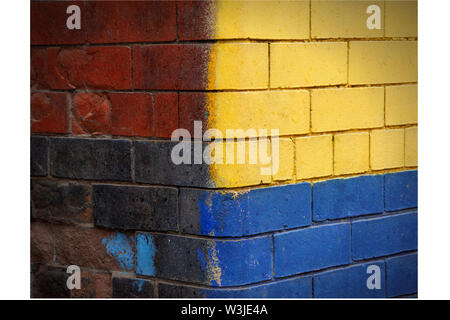 Brightly Painted yellow and blue cement block wall in northern United Kingdom Stock Photo