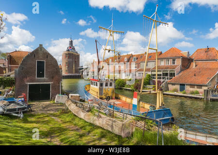 Fishing boat in Enkhuizen in the Netherlands with the historic city gate (Drommedaris) in the background. Stock Photo