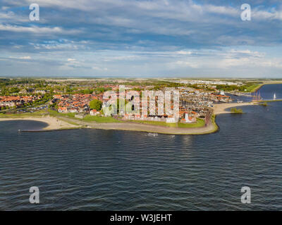 Aerial view of Urk with its lighthouse, a small coastal village on the IJsselmeer in the Netherlands. Stock Photo