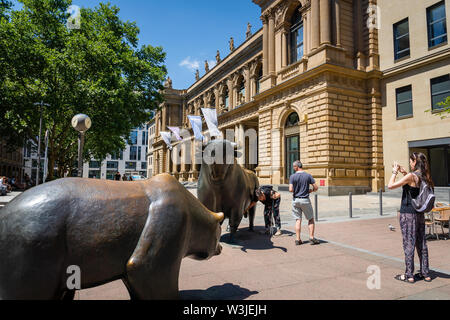 Frankfurt, Germany - July 2019: : Stock exchange building and tourists around bull and bear sculpture. Stock Photo