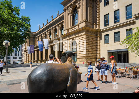 Frankfurt, Germany - July 2019: : Stock exchange building and tourists around bull and bear sculpture. Stock Photo