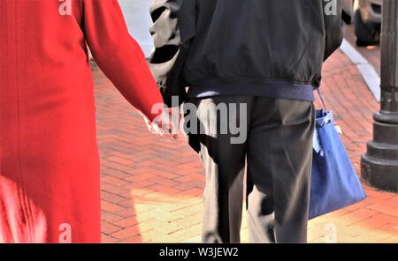 Elderly couple walking while holding hands Stock Photo