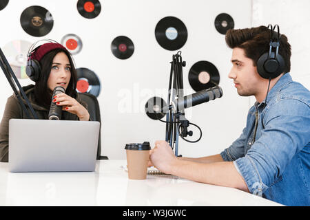 Two radio hosts moderating a live show for radio Stock Photo