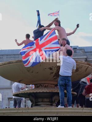 Cricket Fans Celebrate England's World Cup Victory in Trafalgar Square's Fountains and Wave Union Jack Stock Photo