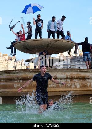 Cricket World Cup Fans Celebrate England's Victory with a Man Jumping Down From Trafalgar Square's Fountain. Stock Photo