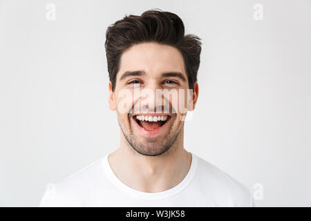 Image of a happy young excited emotional man posing isolated over white wall background. Stock Photo