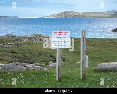 Sign by lay-by requesting payment for overnight parking near Horgabost, Isle of Harris, Scotland Stock Photo