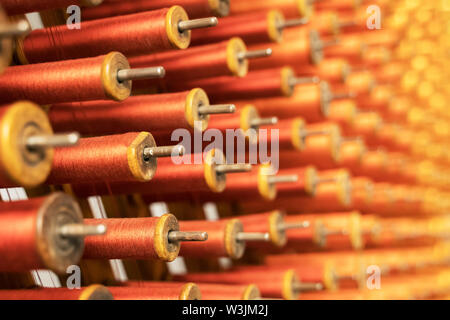 Many multi-colored spool of threads in a sewing factory. Stock Photo