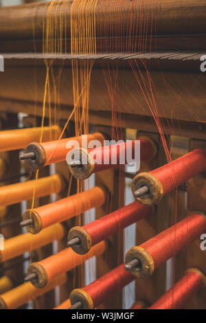 Many multi-colored spool of threads in a sewing factory. Stock Photo