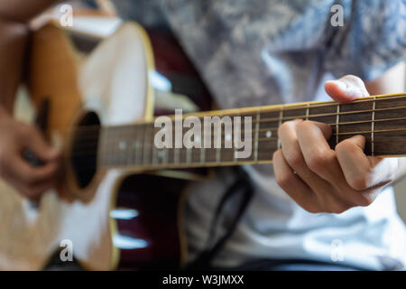 musician plaing acoustic guitar close-up playing chord for jazz rock music Stock Photo