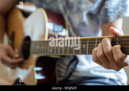musician plaing acoustic guitar close-up playing chord for jazz rock music Stock Photo