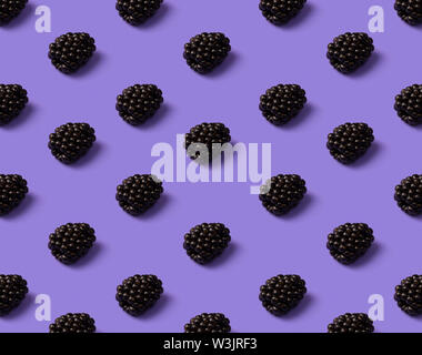 Blackberry pattern on a purple background. Top view Stock Photo