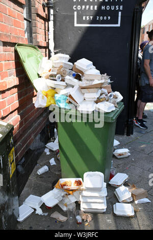 Overflowing rubbish bin, Norwich Lanes Summer Fayre, July 2019, UK Stock Photo