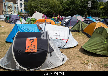 London, UK. 16 July, 2019. Climate activists from Extinction Rebellion relax and prepare for actions at their camp on Waterloo Millennium Green on the second day of their ‘Summer uprising’, a series of events intended to apply pressure on local and central government to address the climate and biodiversity crisis. Credit: Mark Kerrison/Alamy Live News Stock Photo