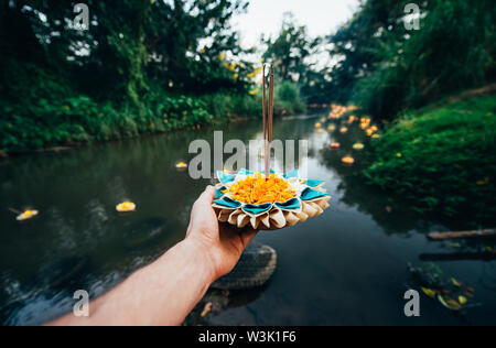 Loy krathong festival, thai new year party with floating buckets release in the river Stock Photo