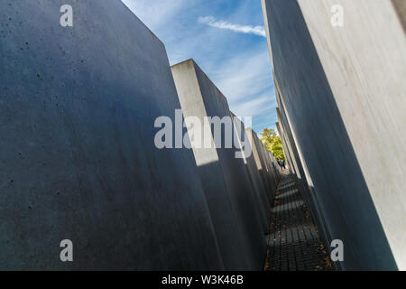 Berlin, Germany - September 23, 2018: Tilted and mysterious view of the tombs of the Memorial to the Murdered Jews of Europe, with a perspective of Stock Photo