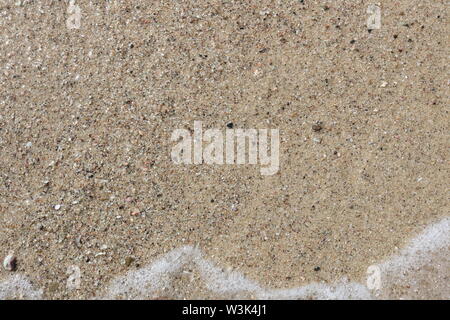 Gentle waves rolling in on beach Stock Photo