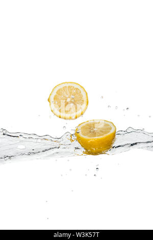 yellow cut lemons with water splash and drops isolated on white Stock Photo