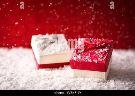 Holiday Christmas background with gift boxes and snow. Stock Photo