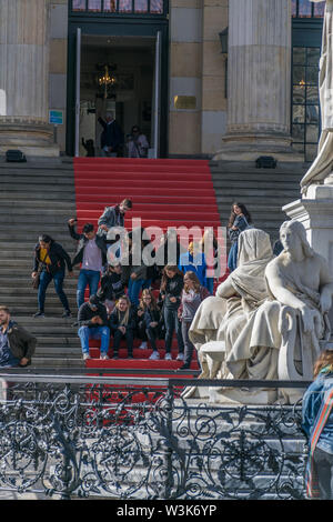 Berlin, Germany - September 23, 2018: Group of people in a red carpet that is on the stairs that lead to the entrance of the Konzerthaus with a white Stock Photo