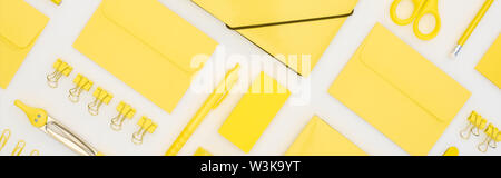 panoramic shot of yellow pen, pencils, paper clips, eraser, stickers, envelopes, stickers, folder, scissors and compasses isolated on white Stock Photo