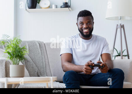 Black man playing video games at home Stock Photo